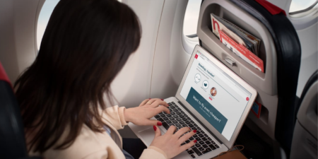 A Norwegian passenger accessing wi-fi on their laptop