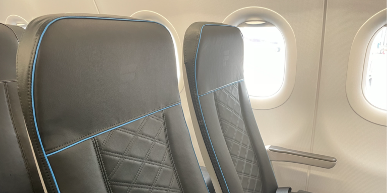 a frontier economy class seat with a padded finish