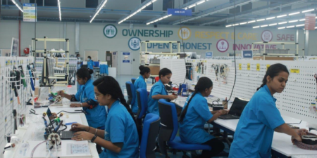 workers assembling wiring systems in the pune india factory