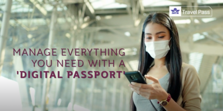 a female passenger checking her digital passport on a smartphone