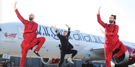 the two brothers bhangra dancing in front of a virgin plane