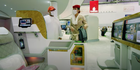 visitors to Arabian Travel Market trying out Emirates plane seats