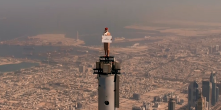 en emirates flight attendant being filmed on top of the burj in dubai