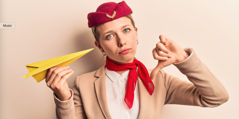 An air stewardess in airline uniform holding a paper plane and looking frustrated