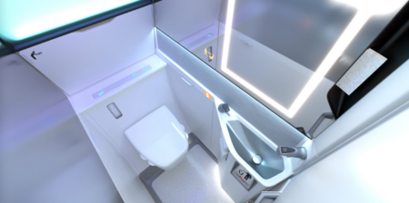 photo of the collins lavatory for the boeing 737. Top view showing an illuminated mirror and grab handles