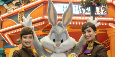 two cabin crew with bugs bunny in between