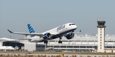 a jetblue airbus a220 taking off from an airport