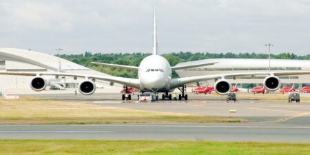 Farnborough, UK - July 25, 2010: Airbus A380 in a heat haze being prepared for take-off with the Red Arrows in the background at the Farnborough Airshow, UK