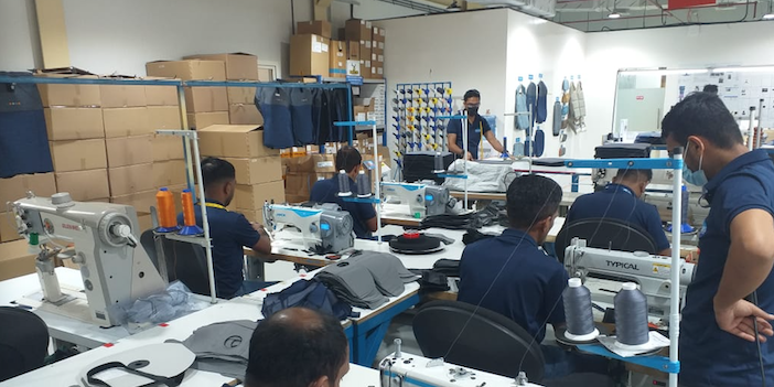 workers stiching seat covers in Soisa's new facility in Dubai