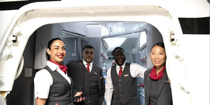 air canada crew welcoming guests at the aircraft door