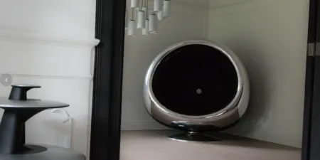 a round chrome chair made from a Boeing 737 engine intake