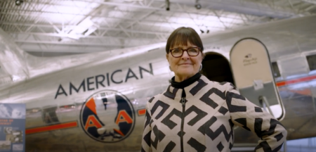 Bonnie Tiburzi Caputo from American Airlines standing in front of a classic airplane