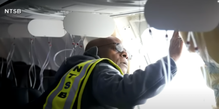 An engineer inspecting the door plugs on a Boeing 737 MAX 9
