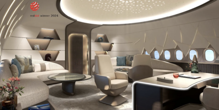 Part of the CelestialStar VIP cabin, with a sofa and desk. The cabin is finished in shades of beige and gold