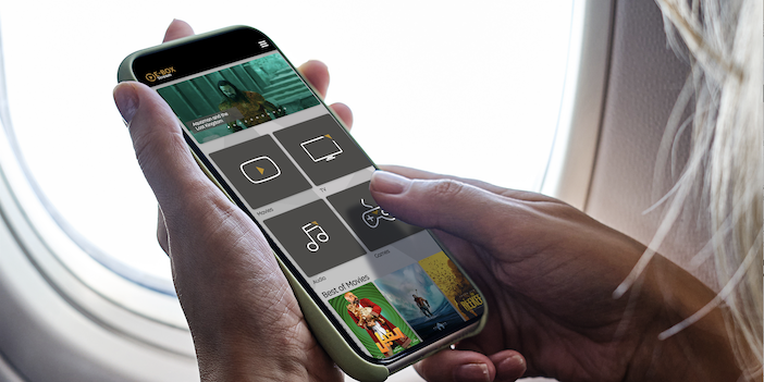 a smartphone being held by a passenger on an airplane using the internet