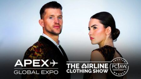 A male and a female airline cabin crew member wearing intricately patterned uniforms