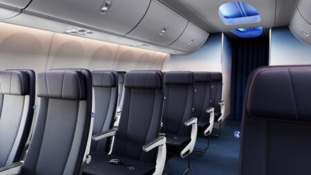 A boeing 737 cabin fitted with dark blue recaro R2 economy class seats