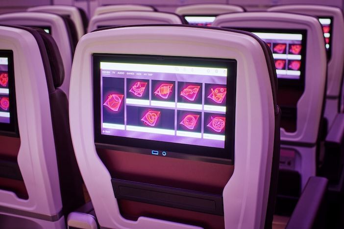 A seatback entertainment screen in a plane showing options for dementia-friendly films