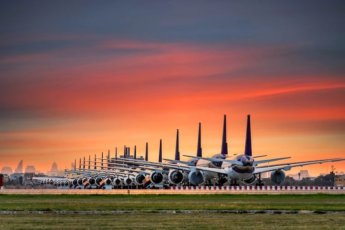 Airplanes are parking at maintenance area, Comercial airplane docking in terminal in the parking lot of the airport waiting for services maintenance, refilling fuel services.