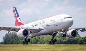 Image shows ZZ336, the RAF's VIP Voyager (Vespina), landing and taxiing into RAF Brize Norton. The white plane has a union flag on the tail, and United Kingdom across the side