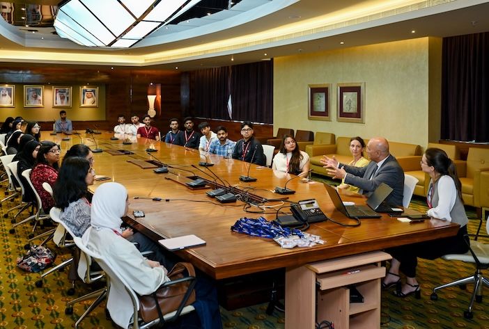 Students sitting at a conference table at Emirates HQ