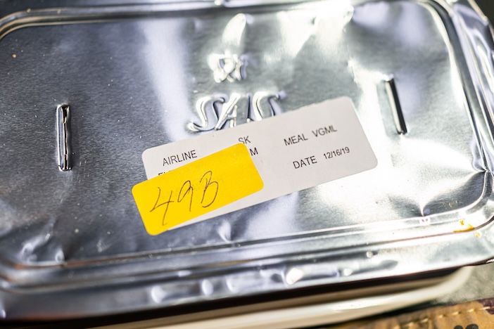 A Vegan food vgml healthy hot meal on an SAS flight with sign and seat number